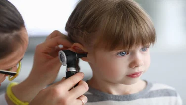 young girl having her hearing tested